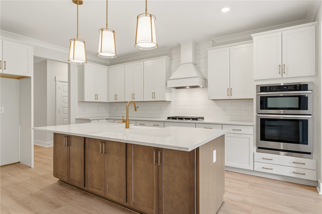203 Timothy Court Anderson, SC 29621 - Photo 7 of 40 A well-lit, open-concept kitchen showcasing a spacious island, premium appliances, and ample cabinetry.