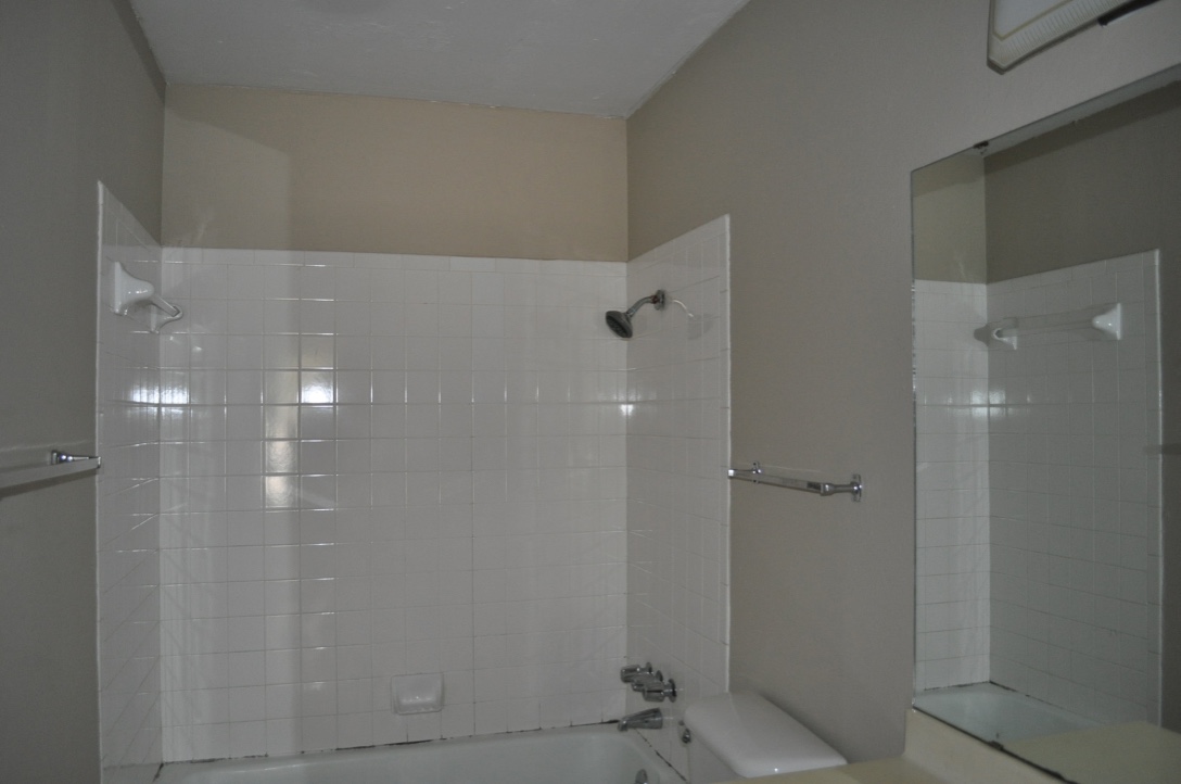 5916 A Cherry Loop Austin, TX 78745 - Photo 4 of 12 A well-maintained tub and shower combination with classic white tiling offers functional comfort.