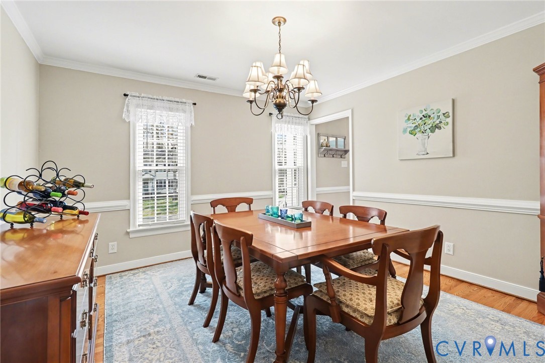 548 Glenmeadow Road Midlothian, VA 23114 - Photo 12 of 31 a view of a dining room with furniture and chandelier
