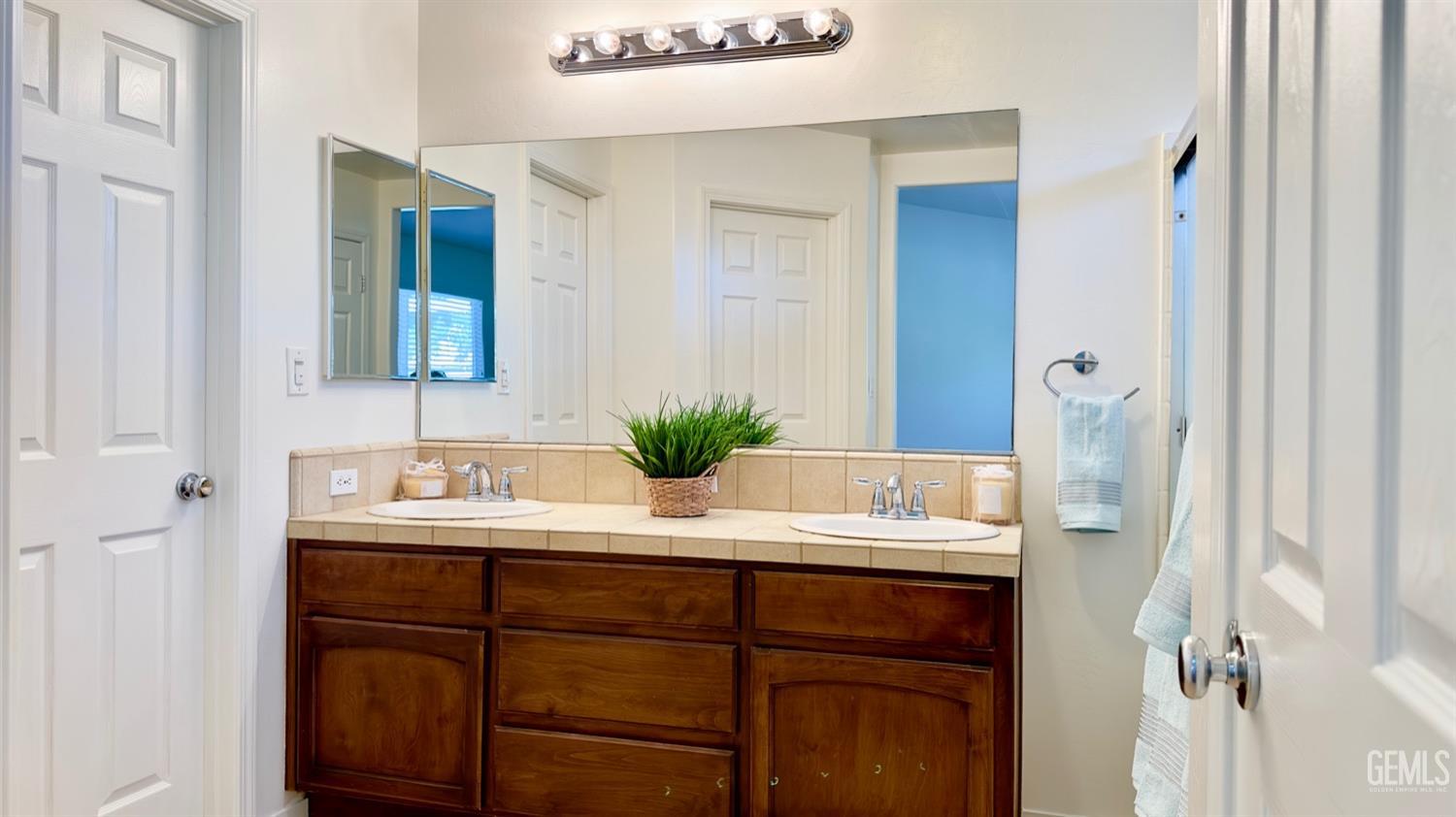 Undisclosed Address Bakersfield, CA 93311 - Photo 17 of 48 a bathroom with a sink and a mirror