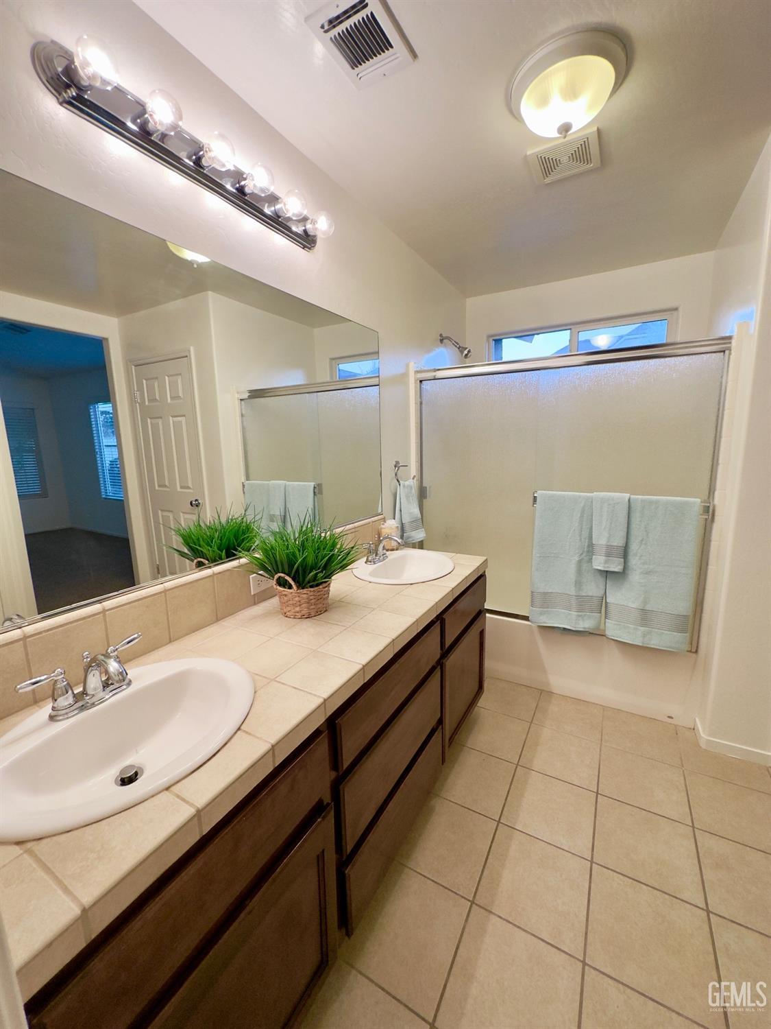 Undisclosed Address Bakersfield, CA 93311 - Photo 18 of 48 a bathroom with a sink a mirror and a bathtub
