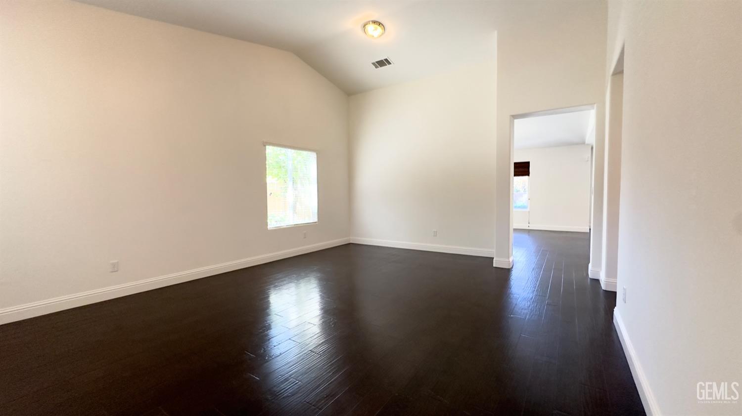 Undisclosed Address Bakersfield, CA 93311 - Photo 3 of 48 an empty room with wooden floor and windows