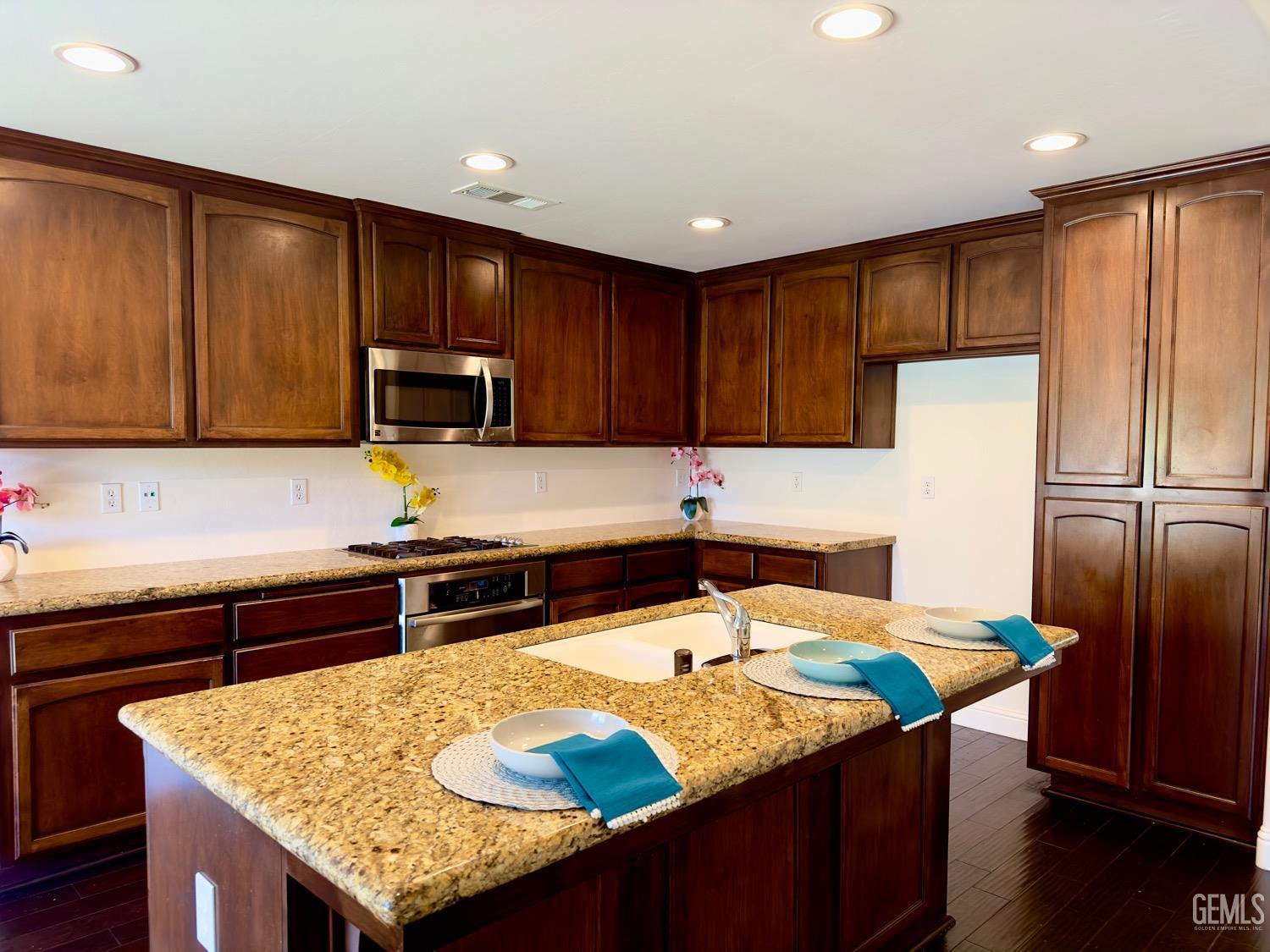 Undisclosed Address Bakersfield, CA 93311 - Photo 4 of 48 a kitchen with granite countertop a sink a stove and refrigerator