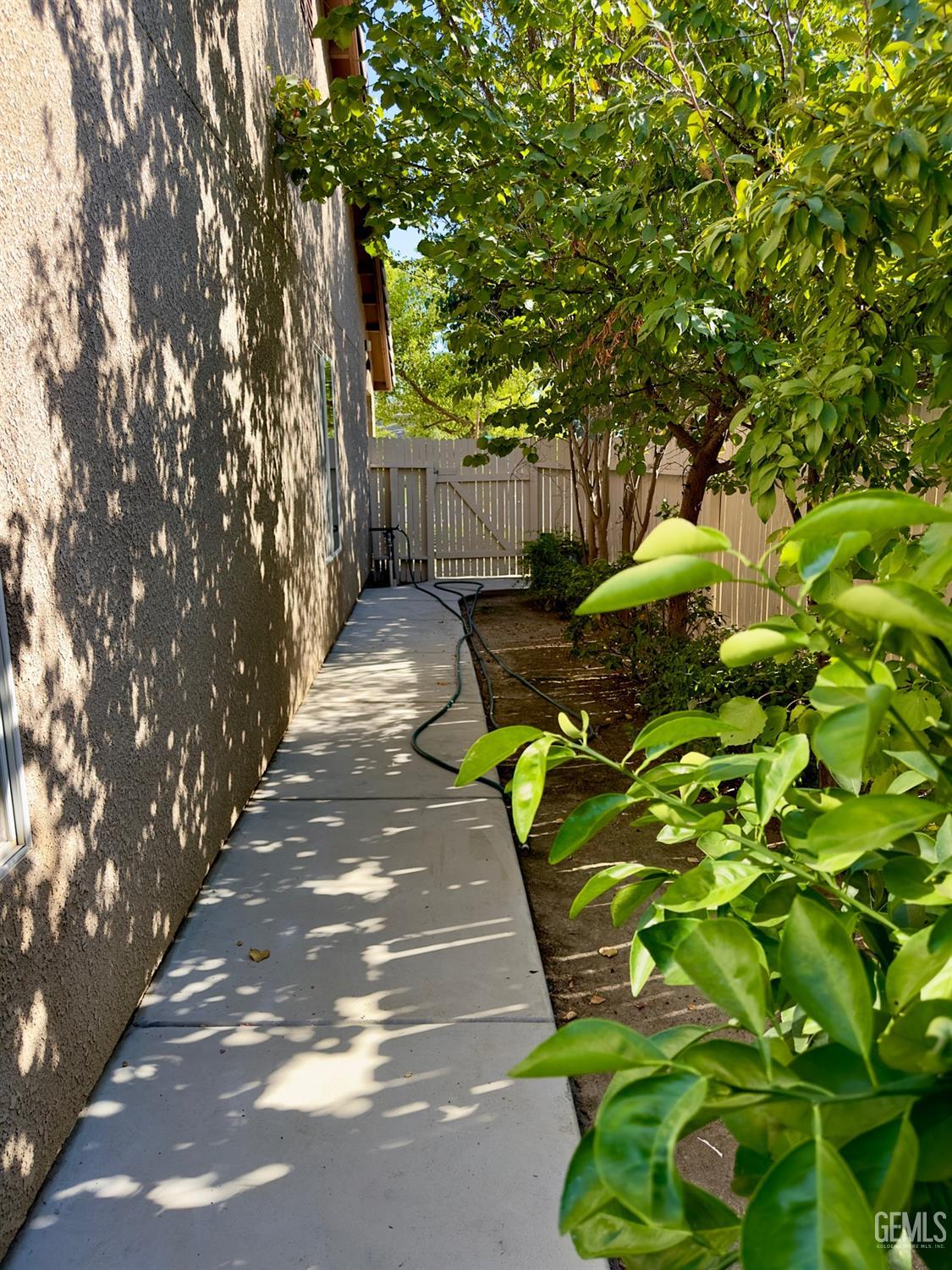 Undisclosed Address Bakersfield, CA 93311 - Photo 46 of 48 a backyard of a house with table and chairs