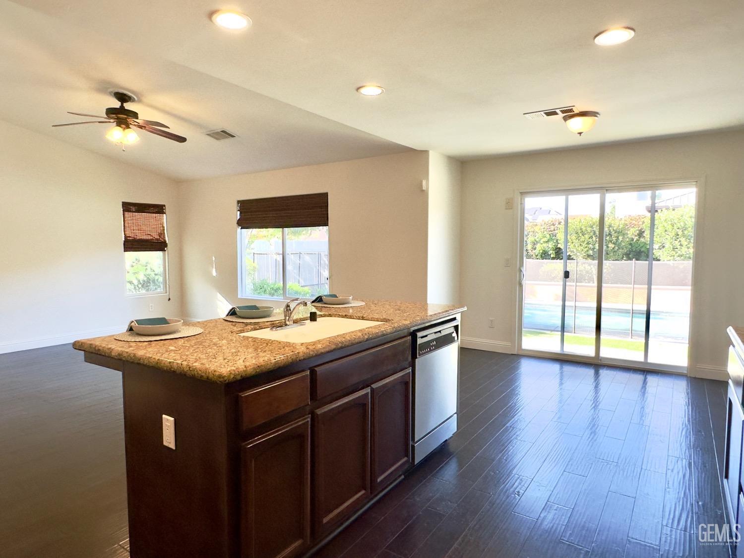Undisclosed Address Bakersfield, CA 93311 - Photo 6 of 48 a kitchen with a stove and wooden floor