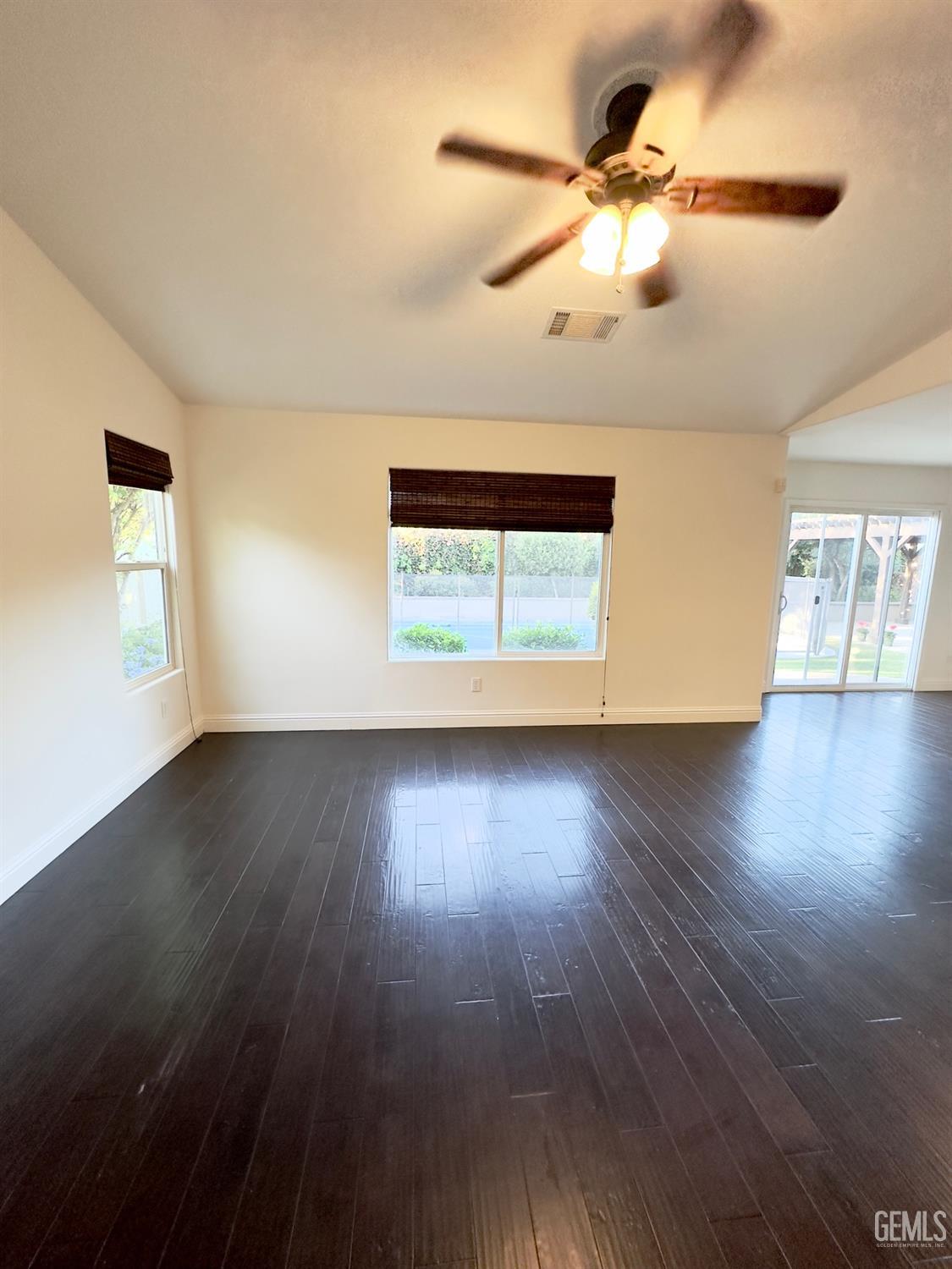 Undisclosed Address Bakersfield, CA 93311 - Photo 9 of 48 a view of an empty room with wooden floor and a window