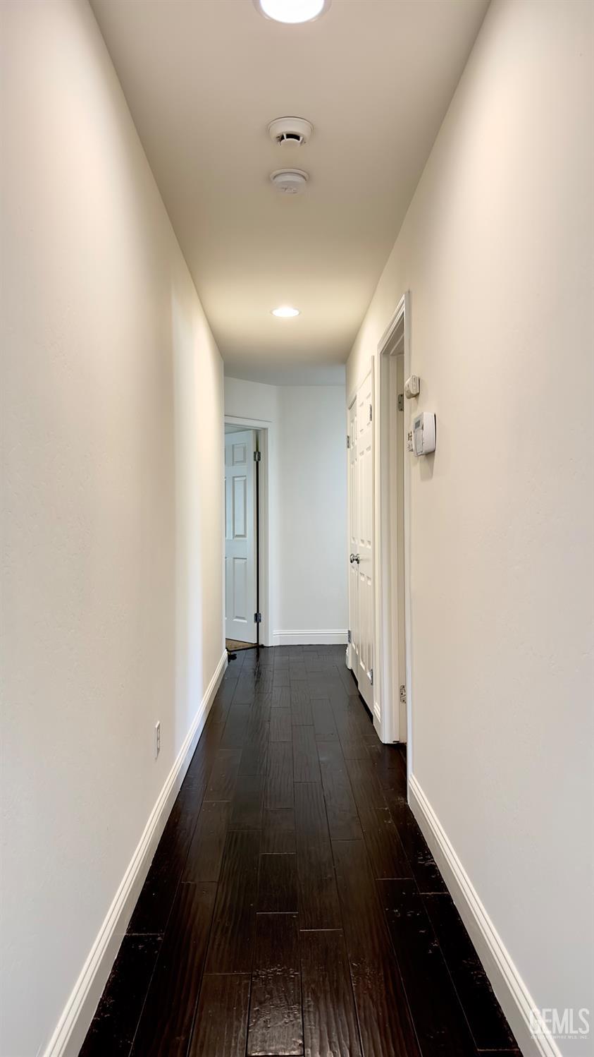 Undisclosed Address Bakersfield, CA 93311 - Photo 10 of 48 a view of a hallway with wooden floor