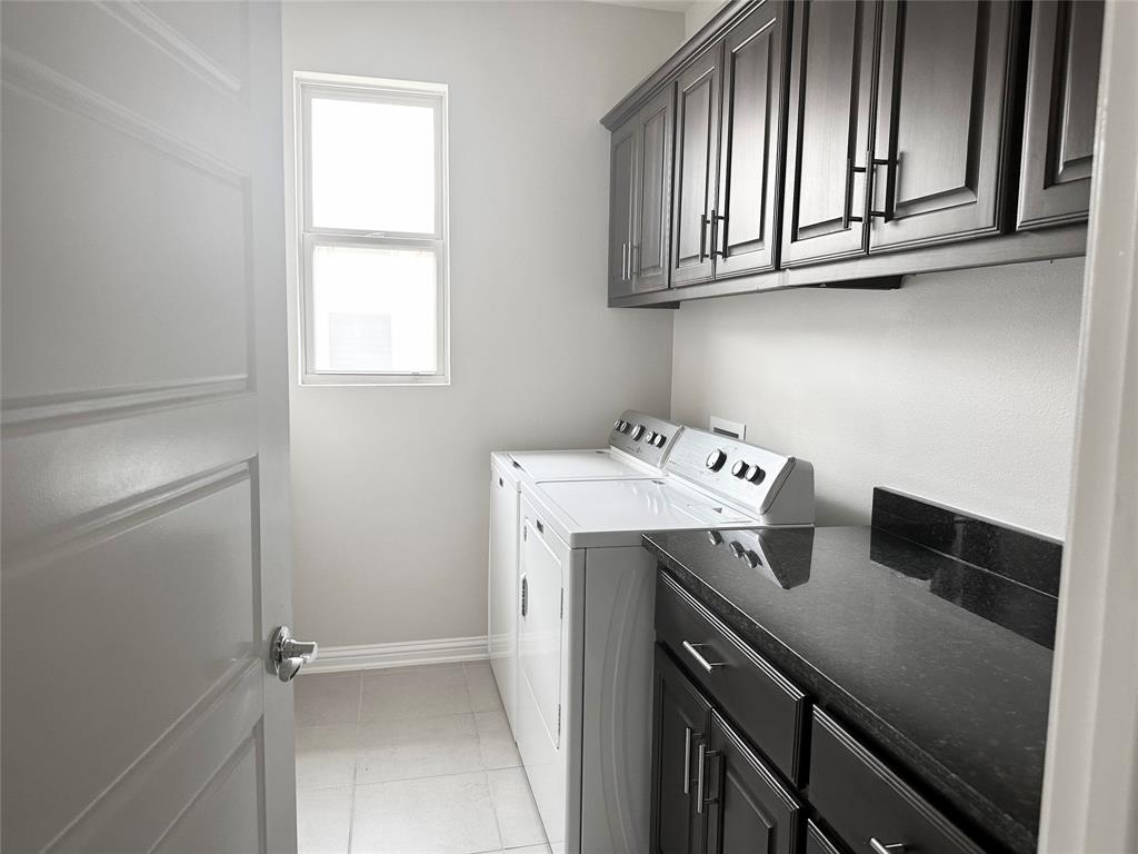 6814 East Riverside Drive, Unit 26 Austin, TX 78741 - Photo 7 of 21 Functional laundry room featuring a convenient countertop and ample storage.
