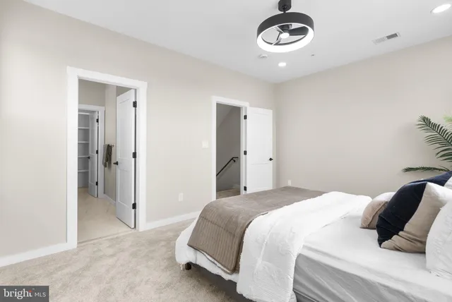 a bedroom with a large bed and a window