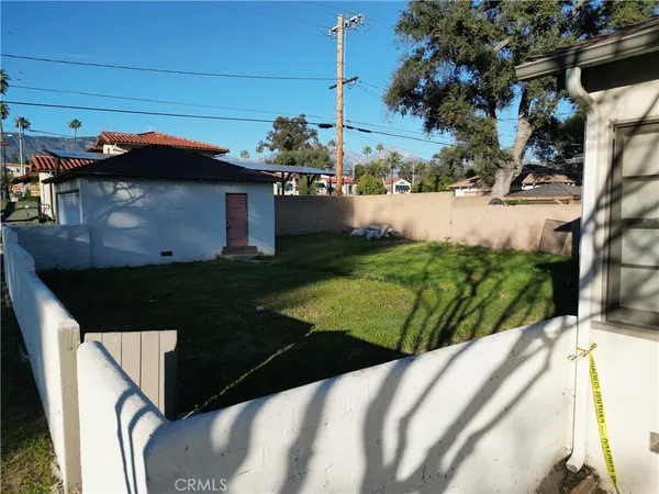 a view of a house with a small yard and a garden