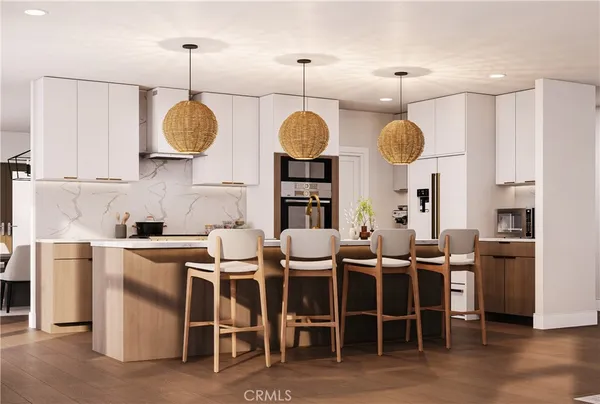 a kitchen with cabinets and chairs