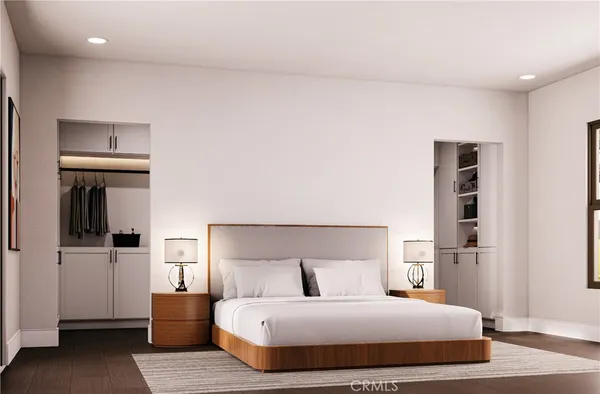 a bedroom with a bed and a refrigerator