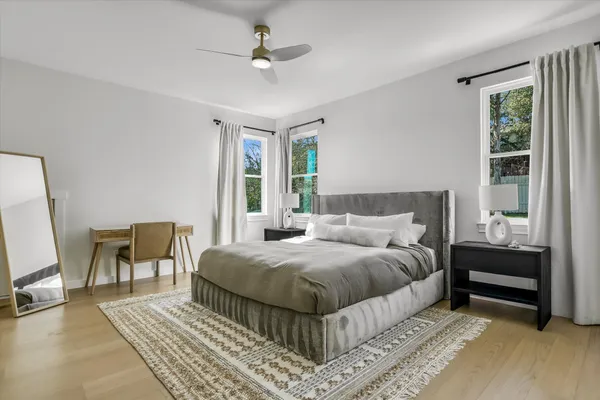 a bathroom with a double vanity sink a toilet and a large mirror