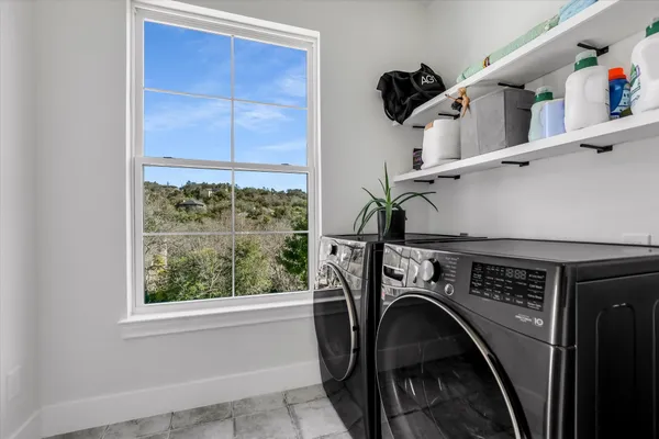 a living room with furniture potted plant and windows