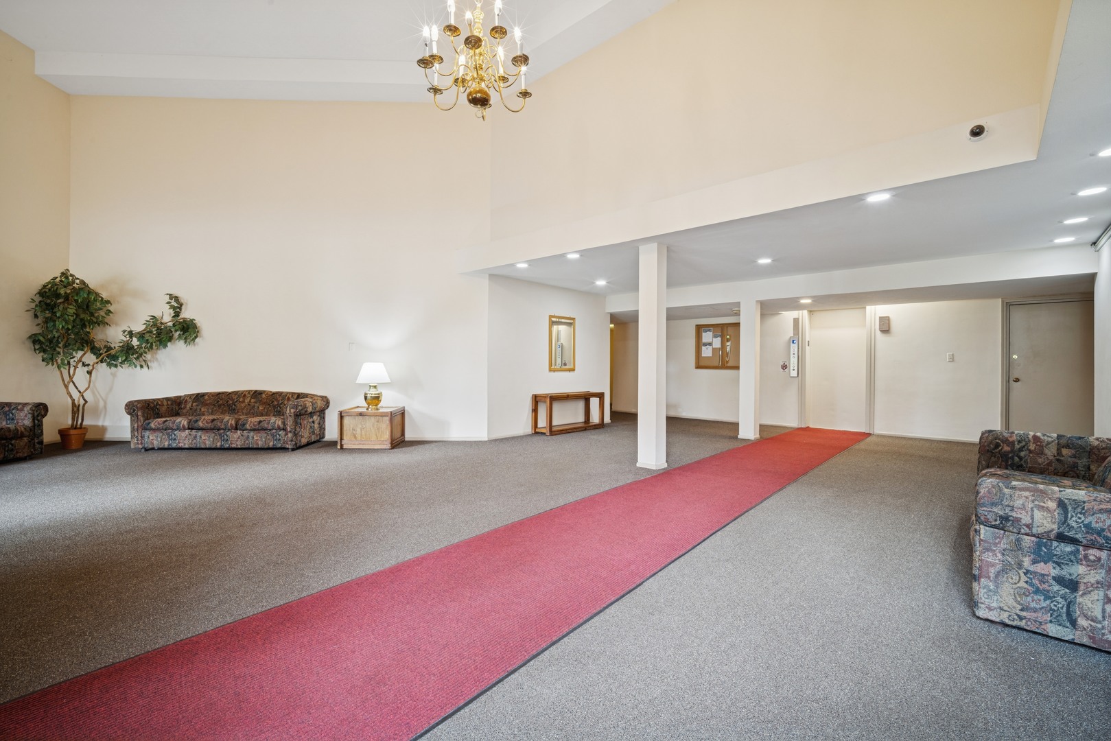 1500 Robin Circle, Unit 101 Hoffman Estates, IL 60169 - Photo 2 of 20 a living room with furniture and chandelier