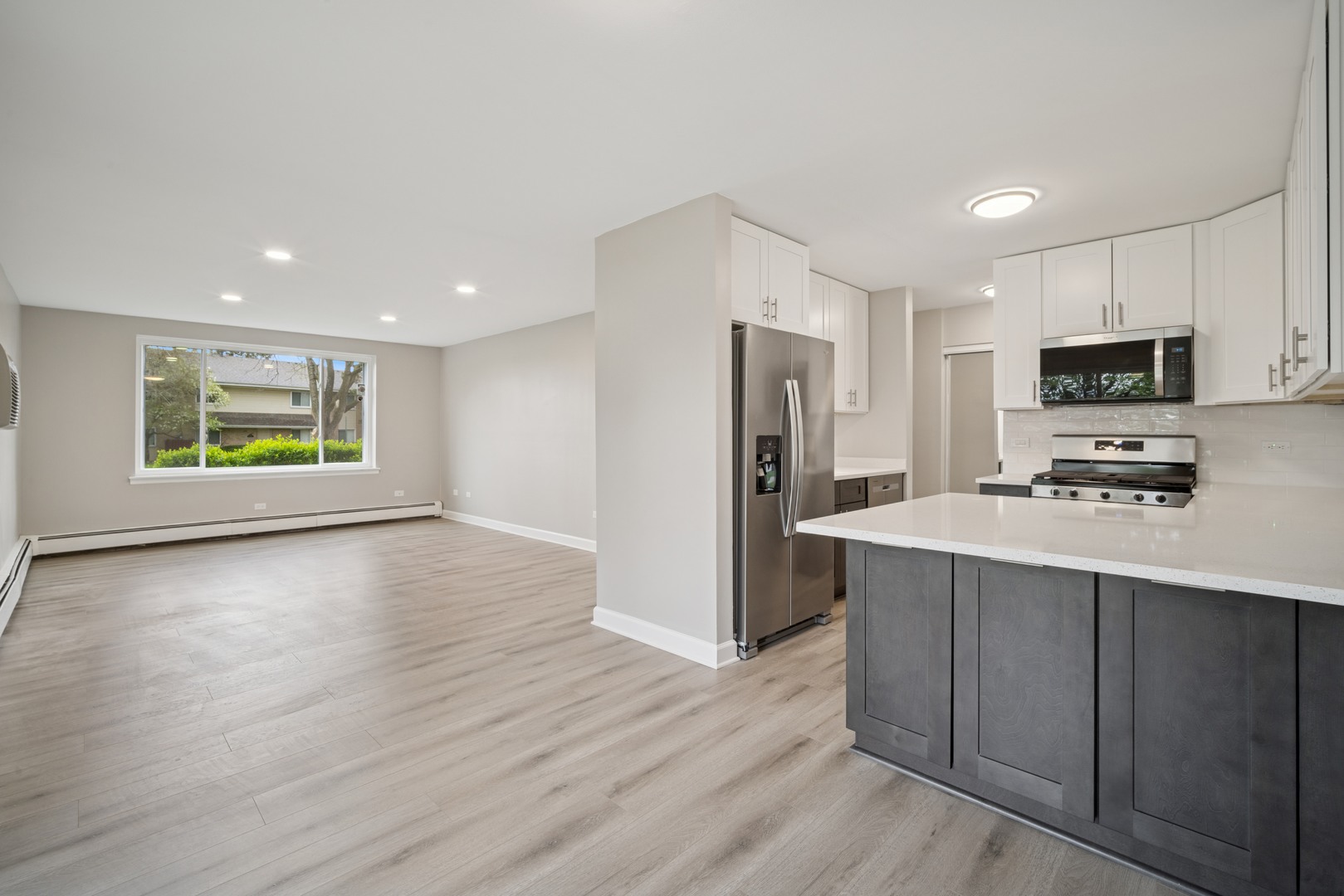 1500 Robin Circle, Unit 101 Hoffman Estates, IL 60169 - Photo 4 of 20 a kitchen with stainless steel appliances a refrigerator stove and microwave