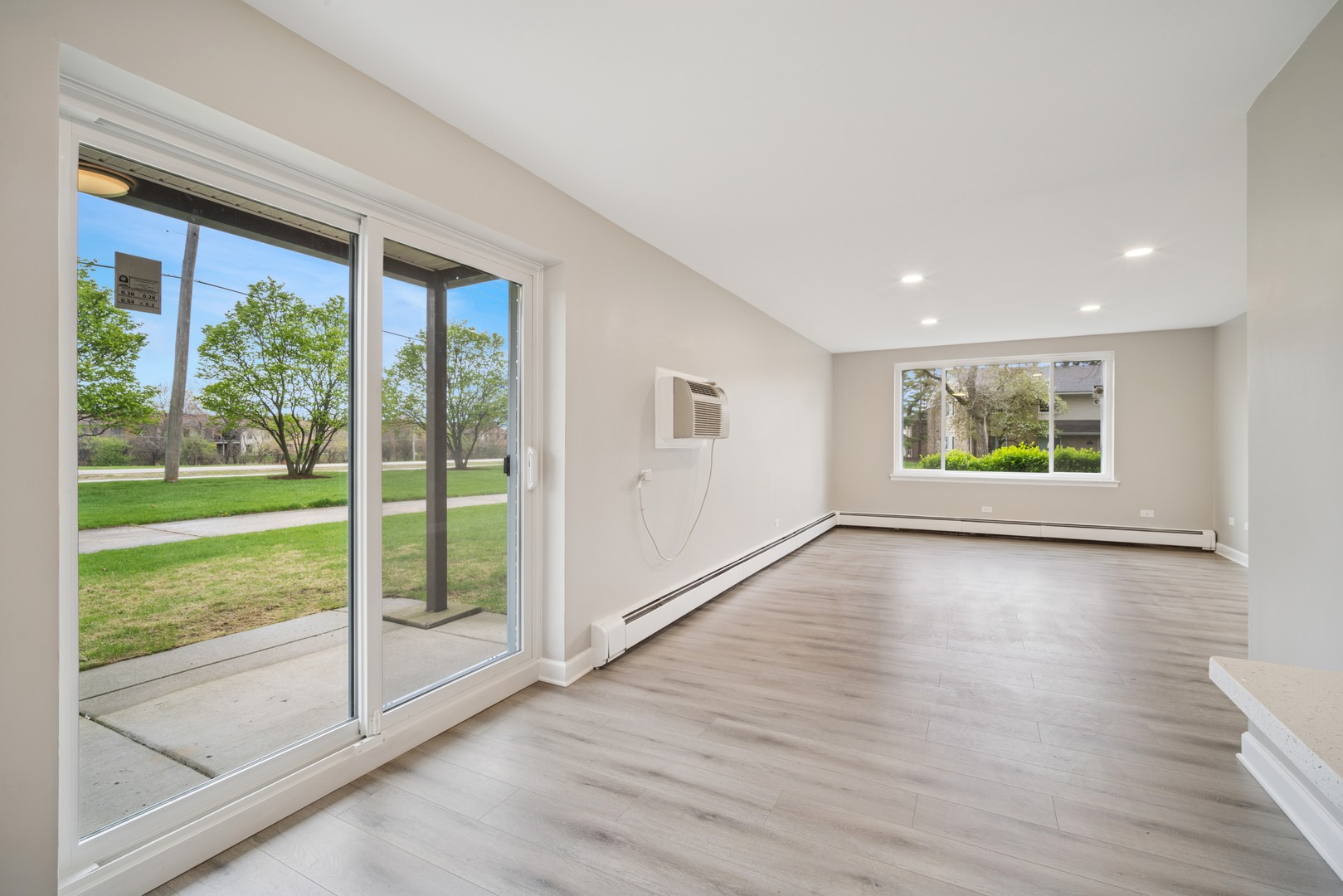 1500 Robin Circle, Unit 101 Hoffman Estates, IL 60169 - Photo 5 of 20 a view of an empty room with wooden floor and a window