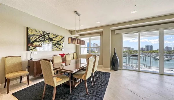 a dining room with furniture and a floor to ceiling window