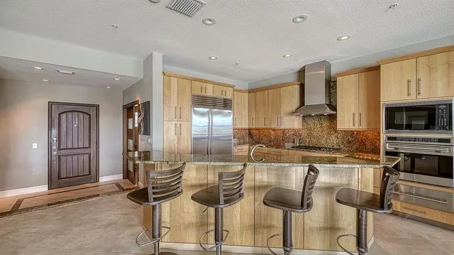 a kitchen with counter top space cabinets and appliances