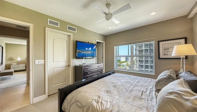 a bedroom with a bed and a chandelier