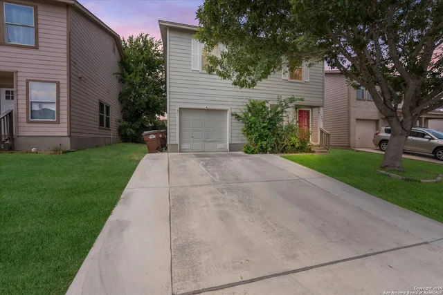 a front view of a house with a yard and a garage