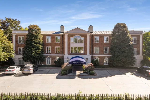 a front view of a residential apartment building with a yard