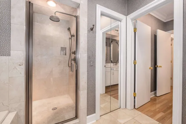 a bathroom with a glass shower door and a sink