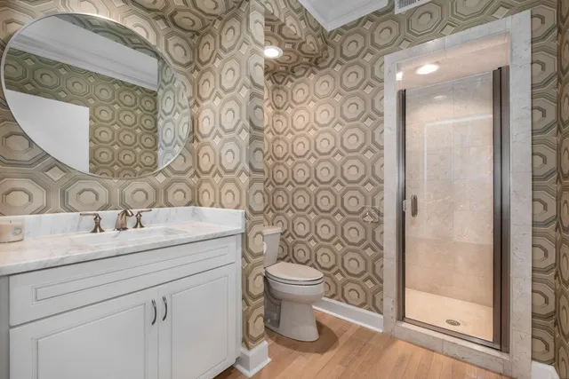 a bathroom with a granite countertop sink a toilet and a mirror