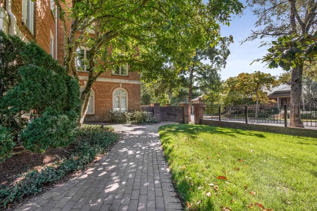 a view of a house with swimming pool and sitting area