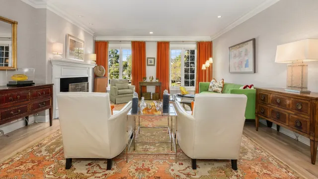 a living room with furniture a large window with kitchen view