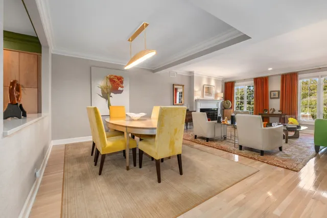 a living room with furniture and a dining table with wooden floor