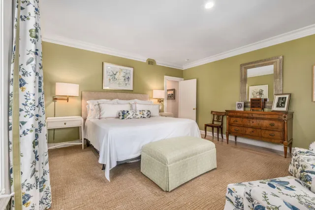 a spacious bedroom with a bed a couch and dresser