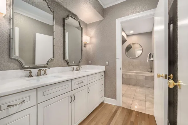 a bathroom with a double vanity sink and a mirror