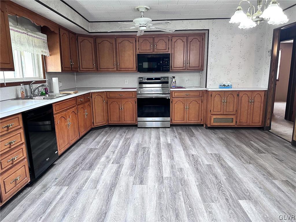 3709 Fairview Street Bethlehem, PA 18017 - Photo 5 of 35 a kitchen with granite countertop wooden floors stainless steel appliances and a sink