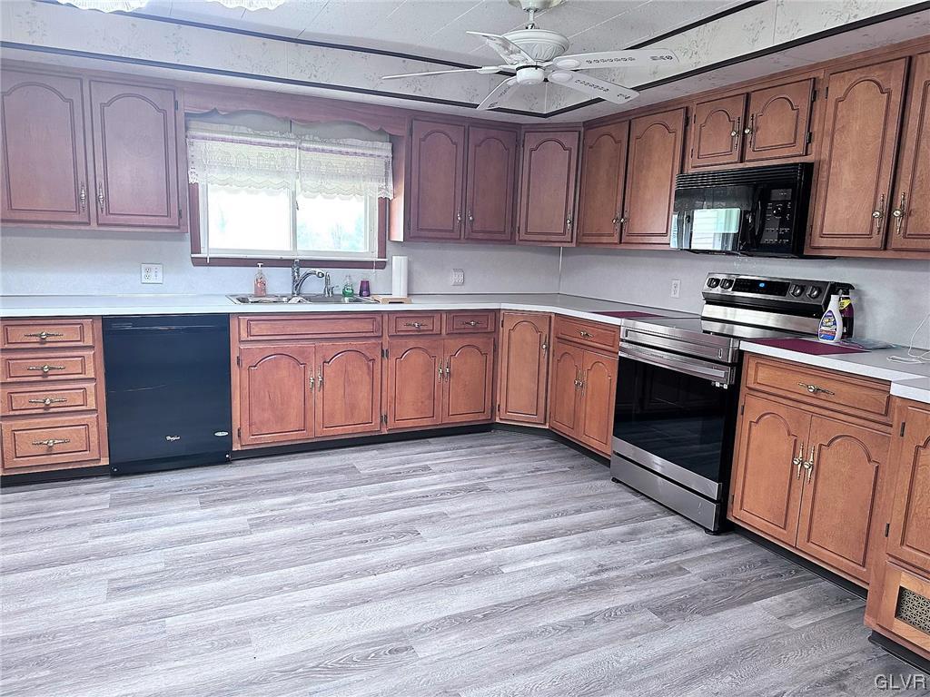 3709 Fairview Street Bethlehem, PA 18017 - Photo 7 of 35 a kitchen with stainless steel appliances granite countertop wooden cabinets a stove a sink and dishwasher with wooden floor