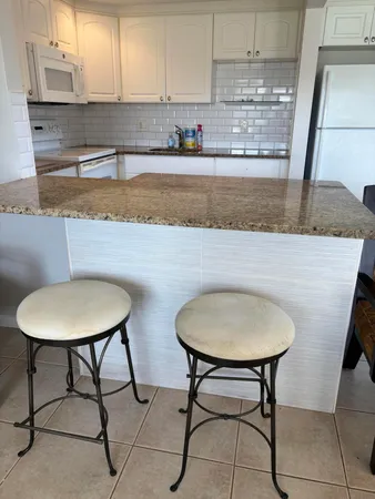 a view of kitchen with sink and window