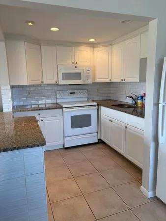 a kitchen with stainless steel appliances granite countertop a sink and cabinets