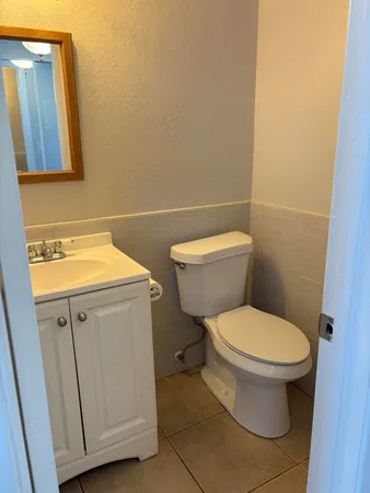 a white toilet sitting next to a bathroom sink
