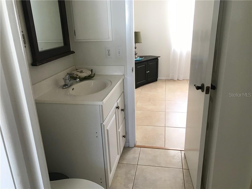 908 Royal Road Venice, FL 34293 - Photo 18 of 30 Jack and Jill bathroom from kitchen to the guest bed room