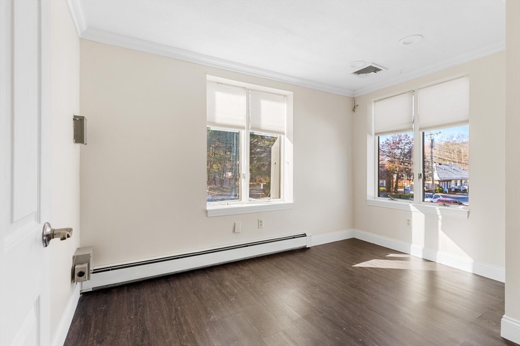 231 Bedford Street Lexington, MA 02420 - Photo 19 of 31 an empty room with wooden floor and windows