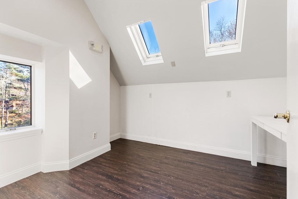 231 Bedford Street Lexington, MA 02420 - Photo 26 of 31 a view of an empty room with wooden floor and a window
