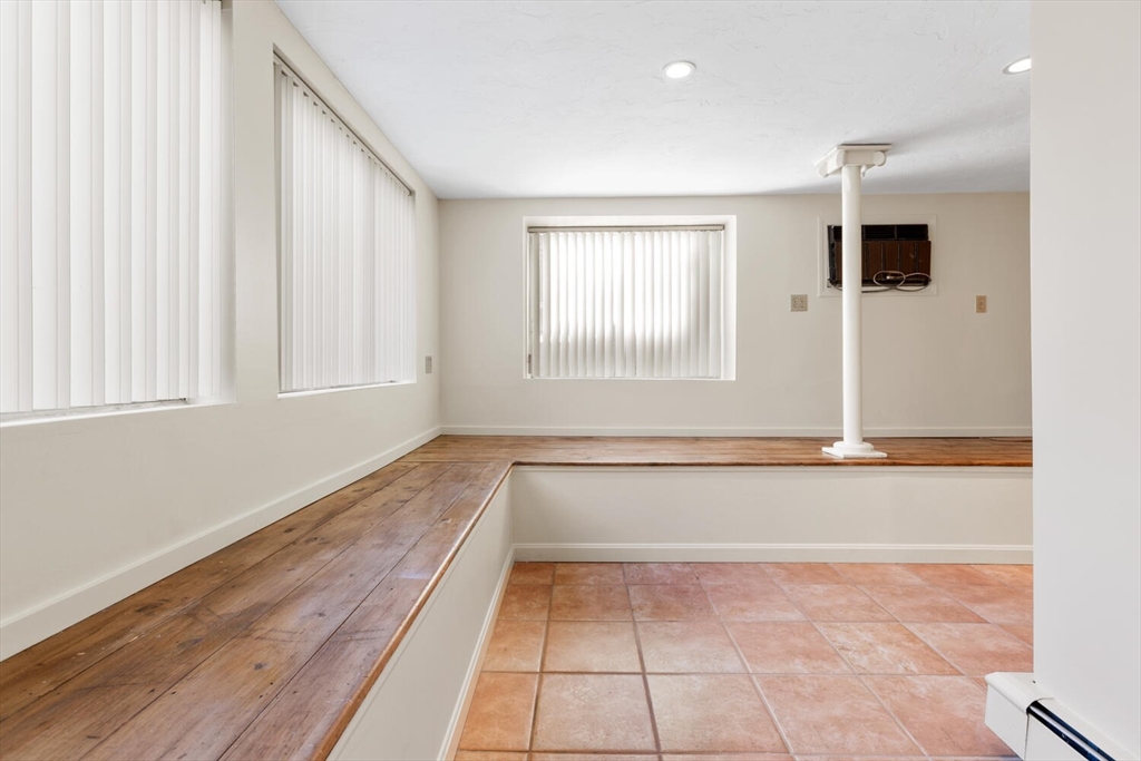 231 Bedford Street Lexington, MA 02420 - Photo 28 of 31 an empty room with wooden floor and windows