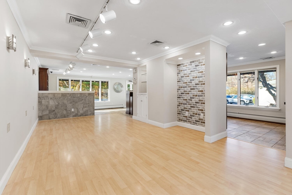 231 Bedford Street Lexington, MA 02420 - Photo 10 of 31 an empty room with windows and pillars in it