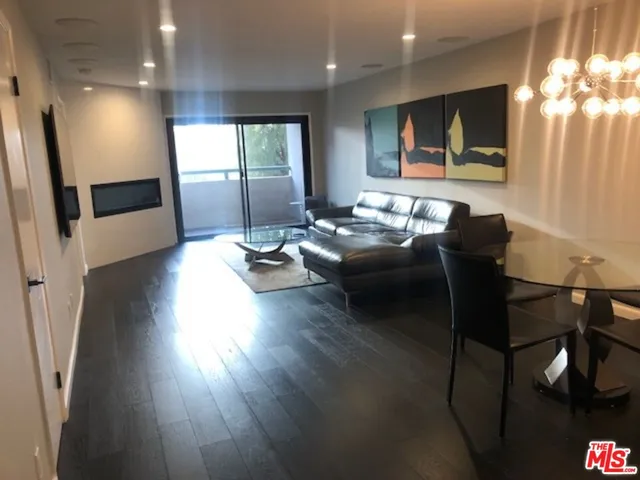 a living room with furniture window and wooden floor