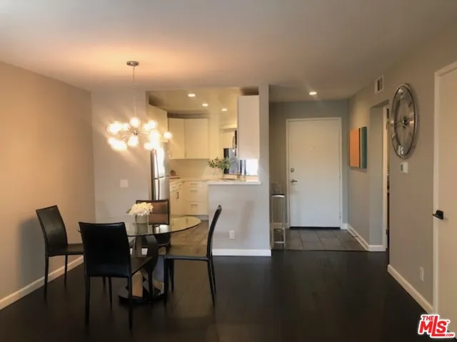 a view of a dining room with furniture and chandelier