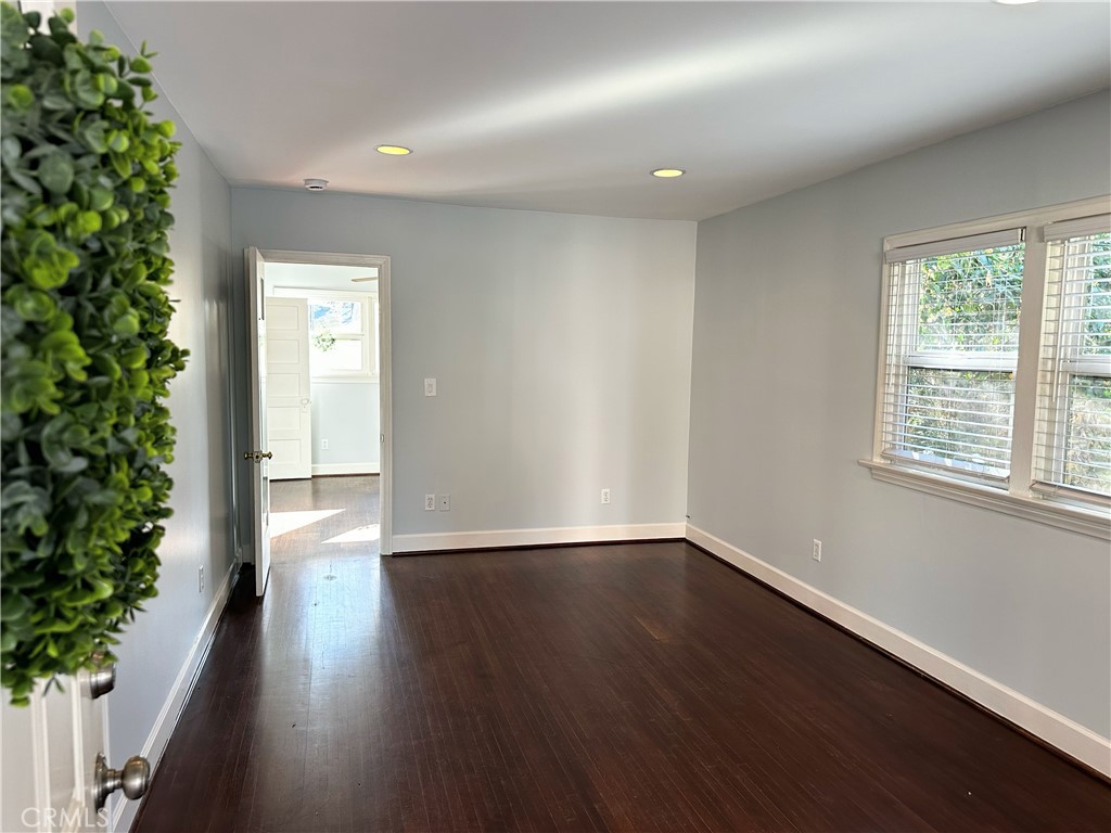 722 East Foothill Boulevard Monrovia, CA 91016 - Photo 3 of 12 an empty room with wooden floor and windows