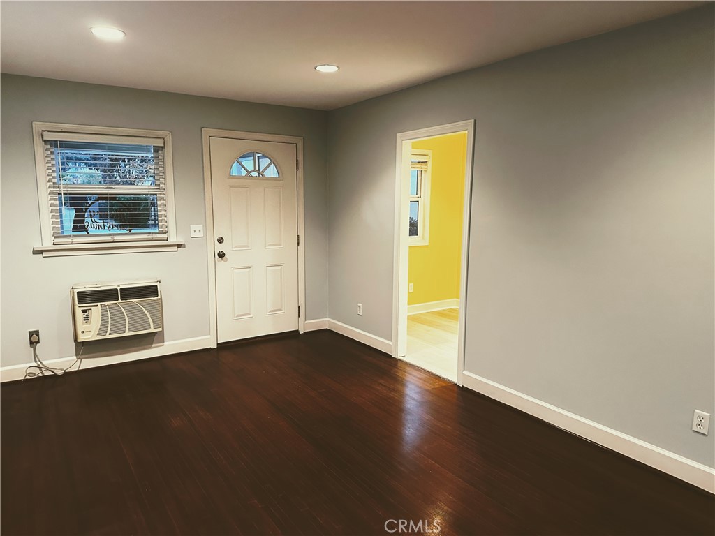 722 East Foothill Boulevard Monrovia, CA 91016 - Photo 4 of 12 a view of an empty room with wooden floor and a window