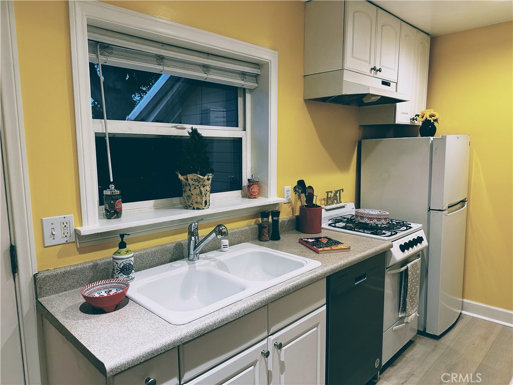 722 East Foothill Boulevard Monrovia, CA 91016 - Photo 5 of 12 a kitchen with a sink and a refrigerator