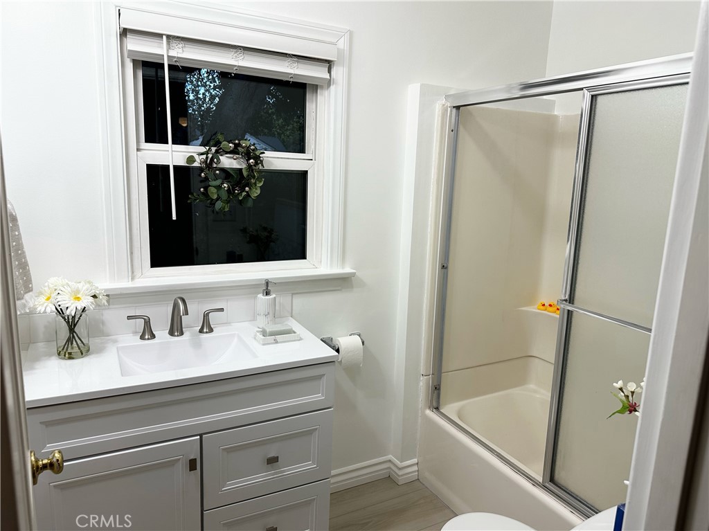 722 East Foothill Boulevard Monrovia, CA 91016 - Photo 8 of 12 a bathroom with a shower sink vanity and mirror