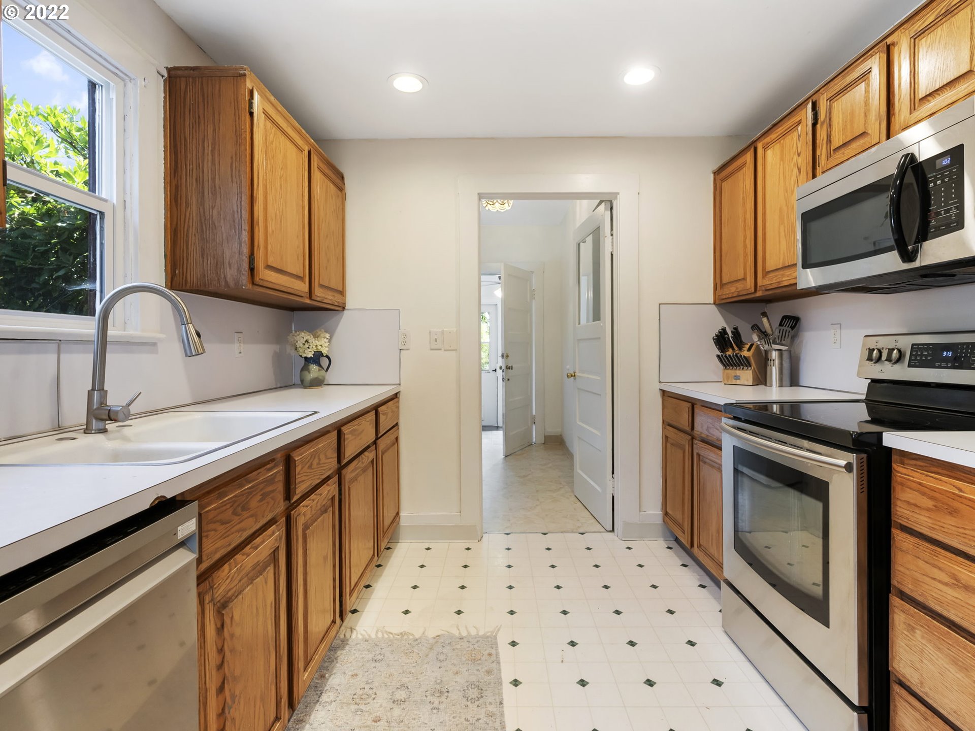 1689 Southwest Stringtown Road Forest Grove, OR 97116 - Photo 13 of 28 a kitchen with stainless steel appliances a sink a stove a refrigerator cabinets and a sink